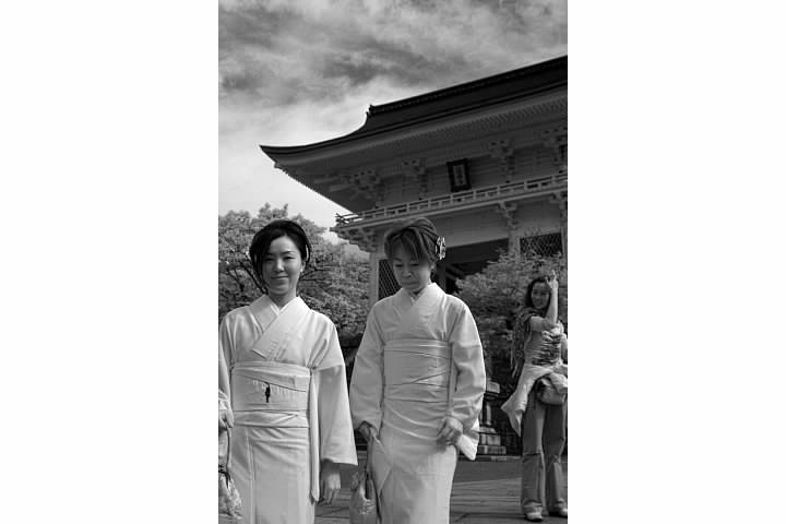 Women visiting Kiyomizu-dera in Kyoto.  IR reduces the appearance of skin blemishes but may cause the subject's eyes to look very dark.  IR often reveals the underlying character of a material, as pigments are designed to produce color in the visual spectrum, not infrared!  Thus clothes often appear much lighter in IR photos.  Lowell Silverman photography, 2007